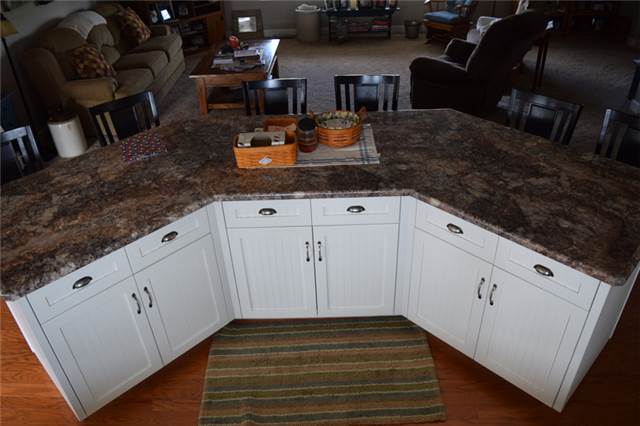 Painted large island with flat panel beadboard doors - full overlay style - laminate countertop